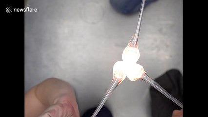 Three molten glass bubbles unite into one satisfying sphere