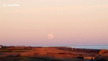 First full moon of 2020 - known as wolf moon - seen rising over seaside town in Essex, UK