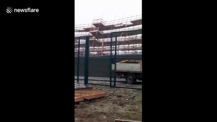 Shocking moment construction blows over due to Storm Brendan's winds in Ireland