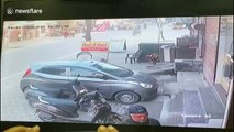 Driver still at large after speeding car hits cyclists before losing control and crashing into parked car in northern India