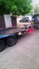 Man Has Trouble Getting Car onto Trailer