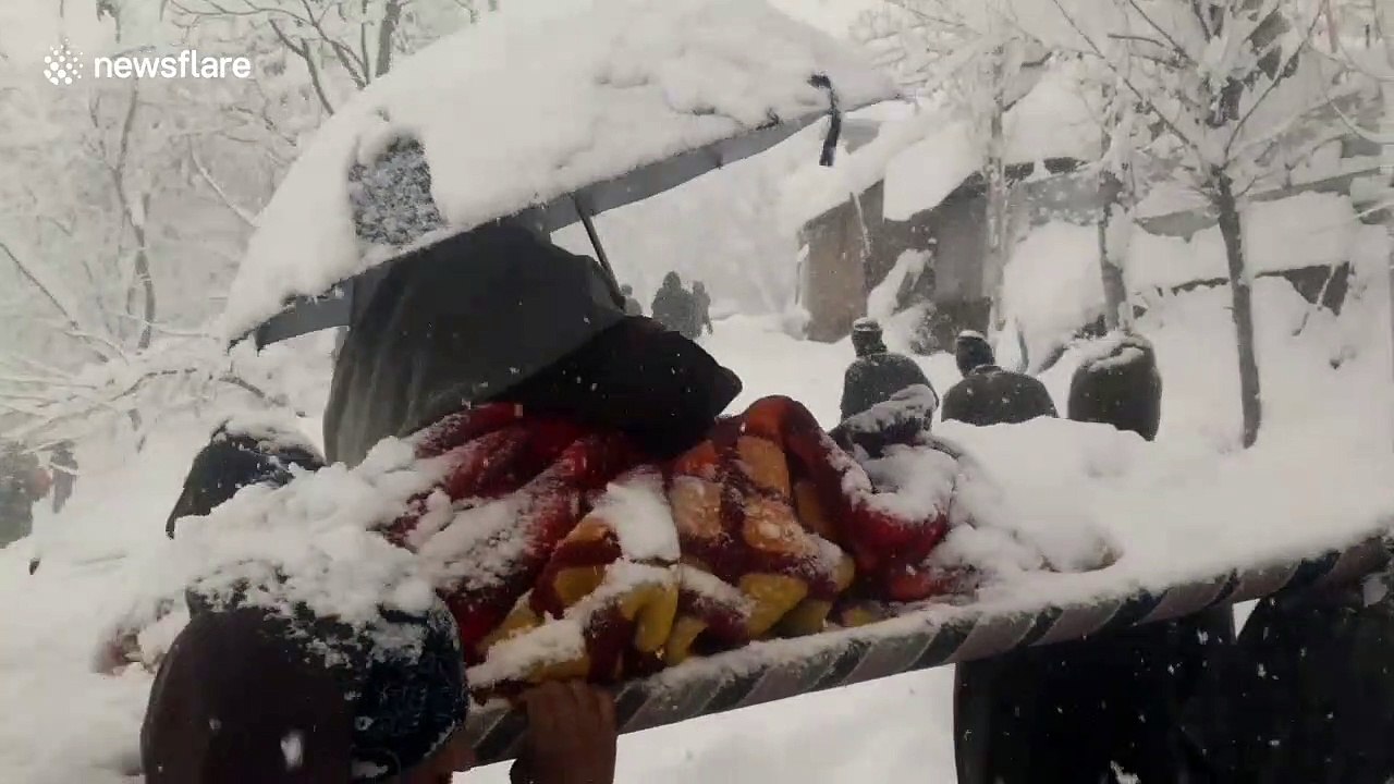 Army carries pregnant woman through waist-deep snow to hospital in India where she gives birth to healthy baby boy