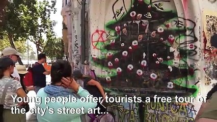 Chilean guides explain protests to tourists through street art tour