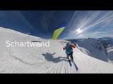 Man Amazingly Speedflies Above Snow Capped Mountains While Wearing Ski Boards