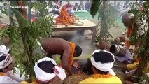 Hindu priest sticks head into firepit for religious festival in northern India