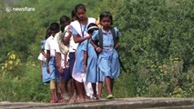 Children risk their lives crossing narrow canal bridge to school in eastern India