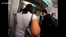 Flights attendants on a Cathay Pacific flight to Hong Kong wear face masks