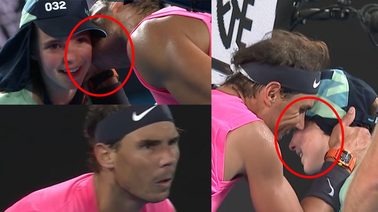 Rafael Nadal kisses a ball girl in between the...