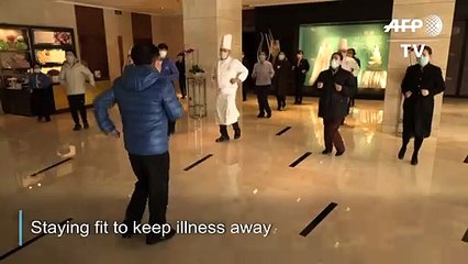 Hotel staff in Wuhan exercise daily to keep virus at bay