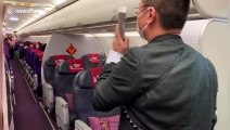 Passengers applaud after their Shanghai flight was rerouted to Wuhan sending residents back home during coronavirus outbreak