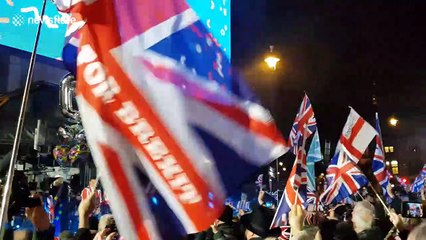 Brexit Day revelers with balloons and flags waving in Parliament Square