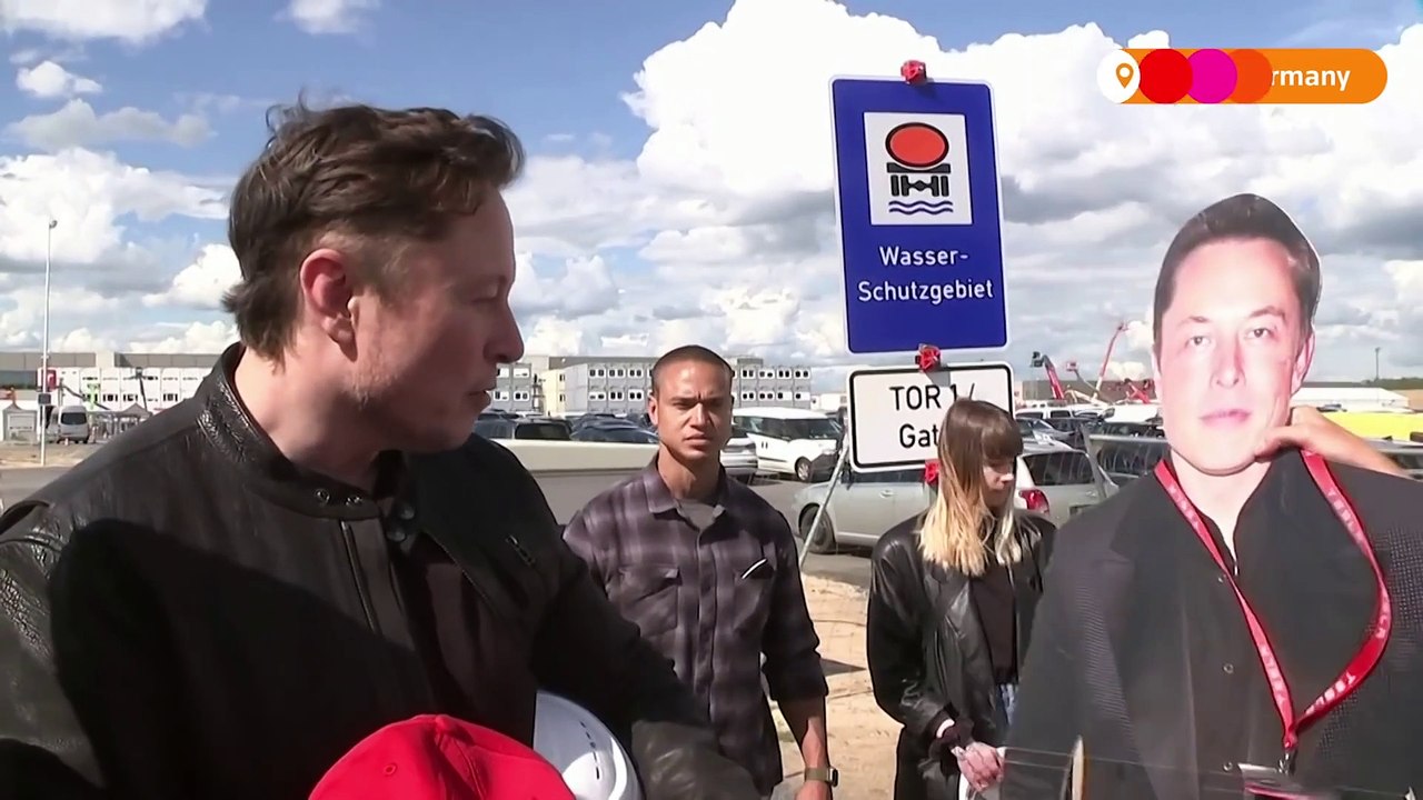 Elon Musk presented with cardboard cutout of himself by fan II Elon