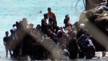 Spanish troops use smoke bombs and batons on migrants trying to enter North African enclave of Ceuta