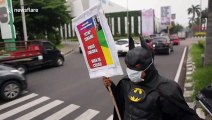 Indonesian man wears Batman costume to educate locals about coronavirus