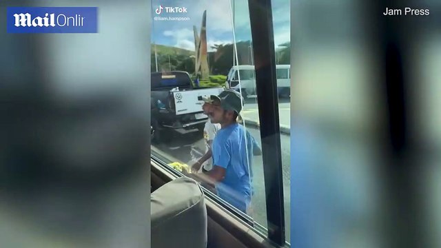 Shocking moment local snatches man's iPad from open window of bus