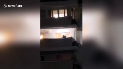 Chinese singer holds concert on balcony to entertain neighbours during coronavirus lockdown