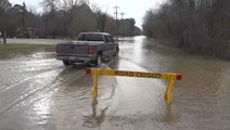 Drivers dangerously proceed down road closed due to flooding