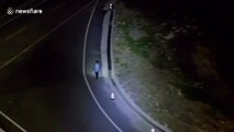 Chinese police officer lights up road using patrol drone for pedestrian walking along at night