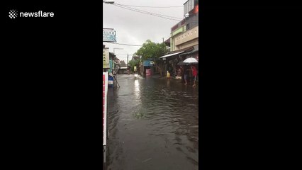 Download Video: Using a scooter these Indonesians are waterskiing in the flood-hit town