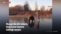 Barınaktan aldığı ayıyla donmuş nehirde buz pateni yaptı