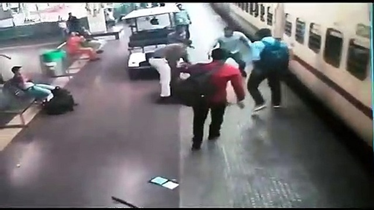 Police officer saves woman falling from train at Indian railway station ...
