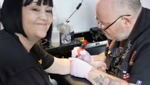 Fundraisers get tattoos to raise awareness of autism and raise money for KAYAKS at Pretty and Ink