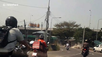 Truck trying to escape the police topples over on sharp bend in Thailand