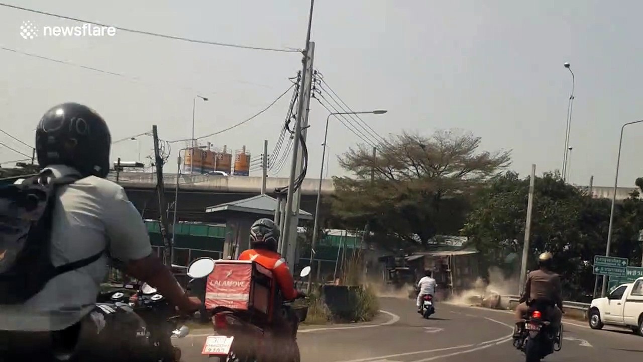 Truck trying to escape the police topples over on sharp bend in Thailand