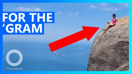 Tourist takes risky shot on the edge of Rio cliff