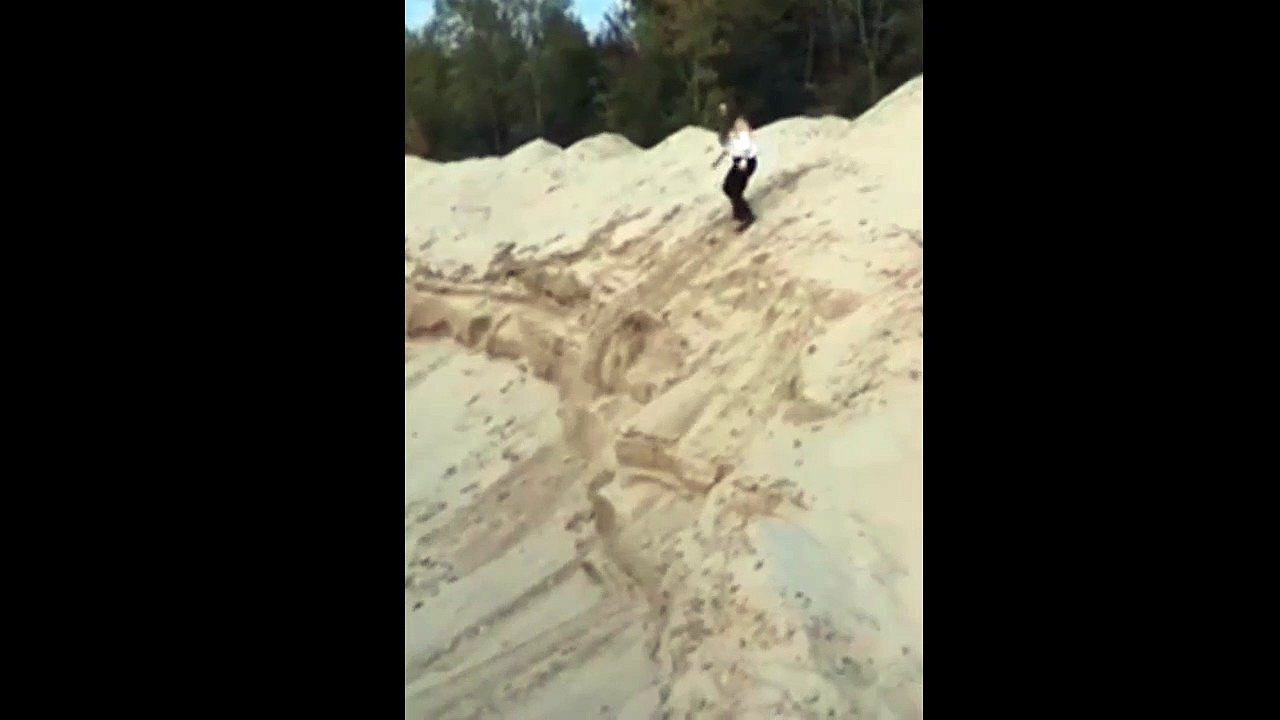 Girl Jumps Down A Mountain Of Sand And Lands On Her Face