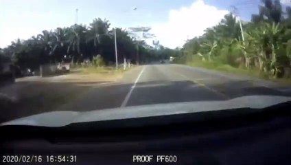 Dust swallows upcoming car after bags of cement falling from truck in Thailand
