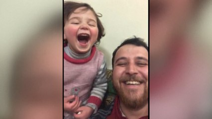 Syria war: father and daughter living in battle zone turn sound of bombs into a game