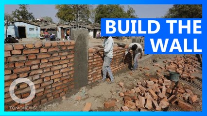 India builds wall to hide poor people during Trump visit