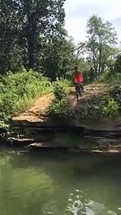 Kid Rides A Bike Into A River