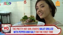 The pretty hot girl enjoys balut grilled with pepper and salt for the first time