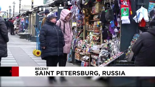 On magnets, mugs and matryoshka dolls, Putin's face still sells