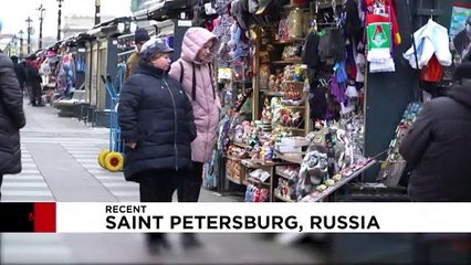 On magnets, mugs and matryoshka dolls, Putin's face still sells