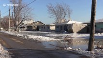 Homes and trees close to Lake Erie coated in ice after freezing winds