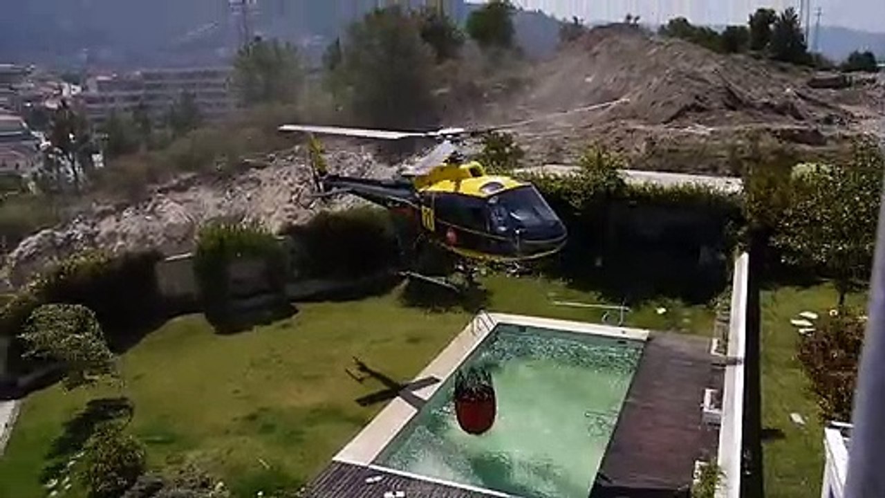 Amazing helicopter pilot taking water from swimming pool Funny Video