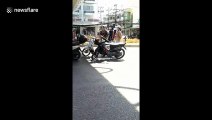 Thai teenagers caught riding without helmets are punished to sing by police