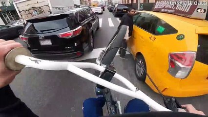 Cyclist Skillfully Weaves His Way through Traffic