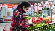 Temperature checks and protective suits at Beijing supermarket