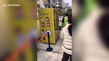 Chinese residents line up to buy face masks from self-service machine