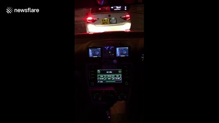 UK taxi driver shows off his vehicle's sound system and disco lights to passenger