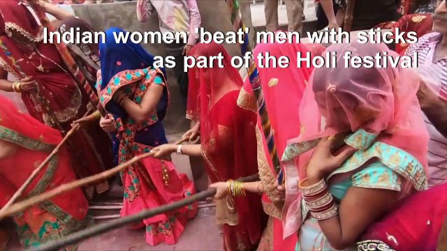 Stick em' up! Indian women 'beat' men during Holi festival