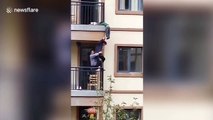 Neighbours rescue boy hanging from balcony's guardrails in China