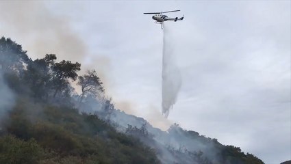 Helicopter drops water on wildfire