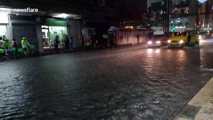 Buses drive through flooded roads in the Philippines