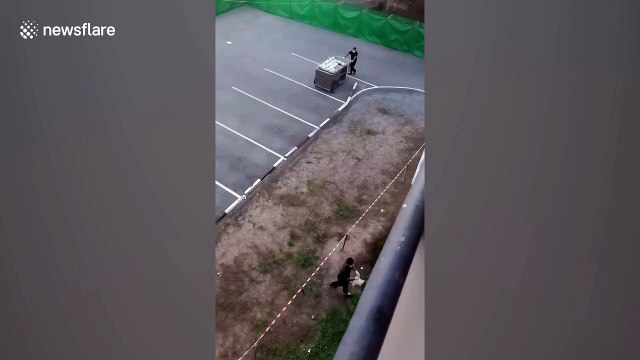 Quarantined workers back from South Korea have food delivered by buckets on ropes in Thailand