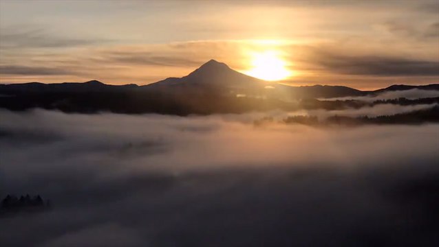 Fog sweeps through the valleys beneath Mount Hood